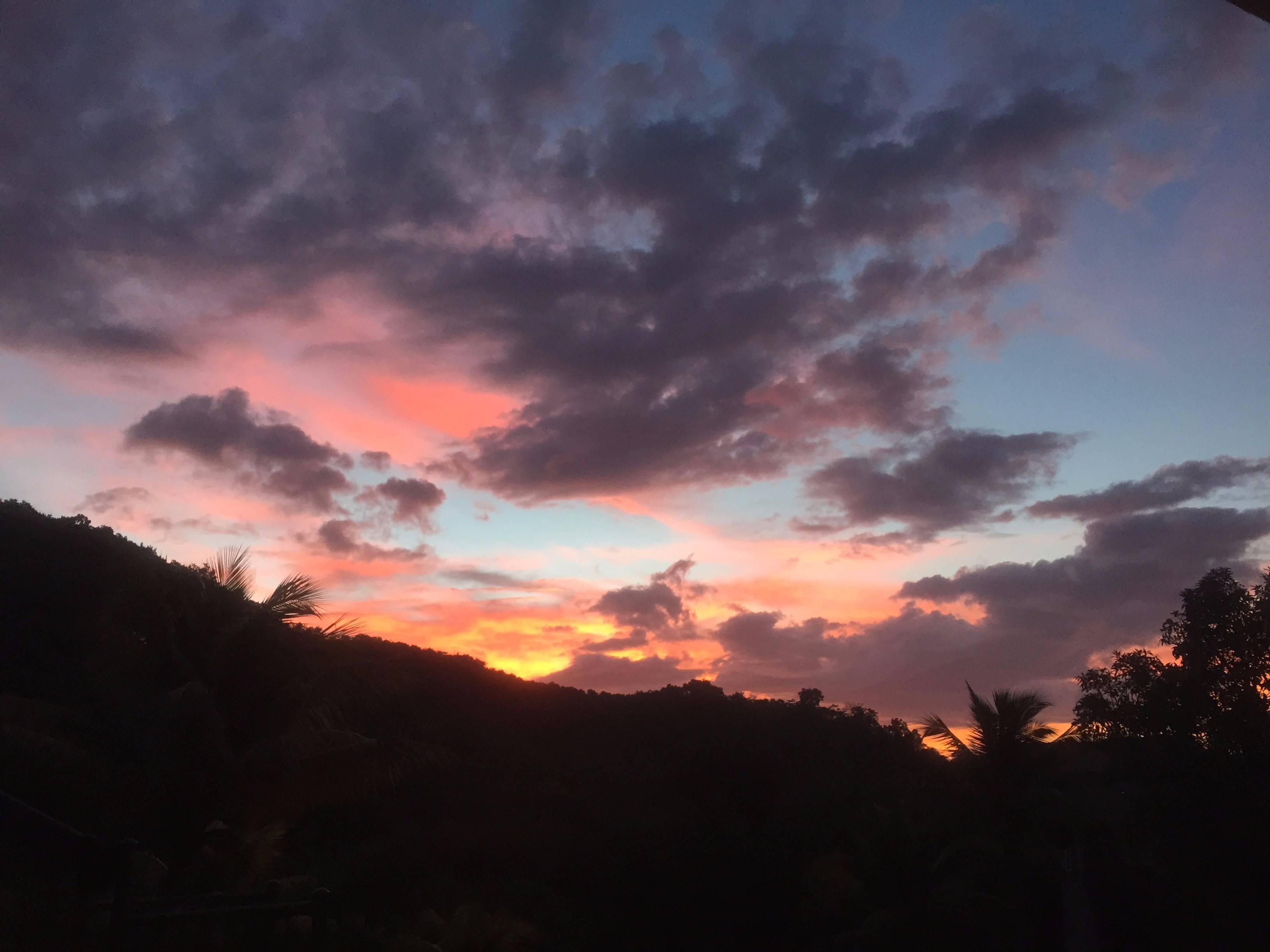 Sunset sky over a hillside in Jamaica.
